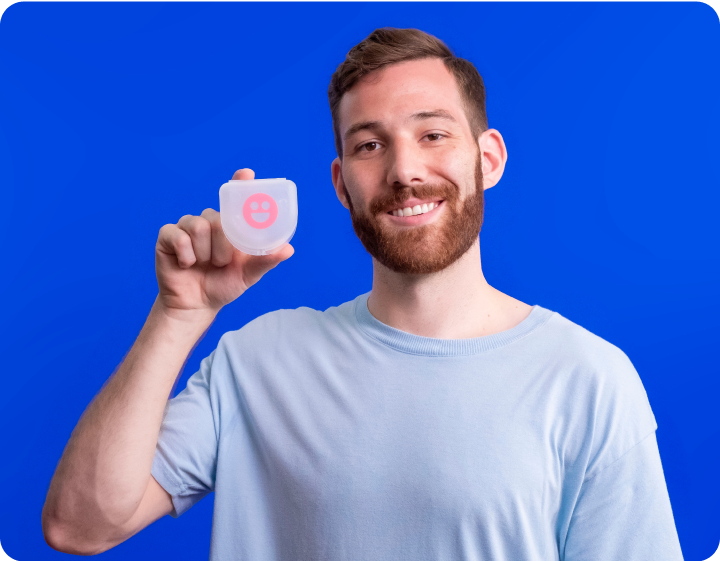 A man is holding a pink cheeky night guards-Cheeky