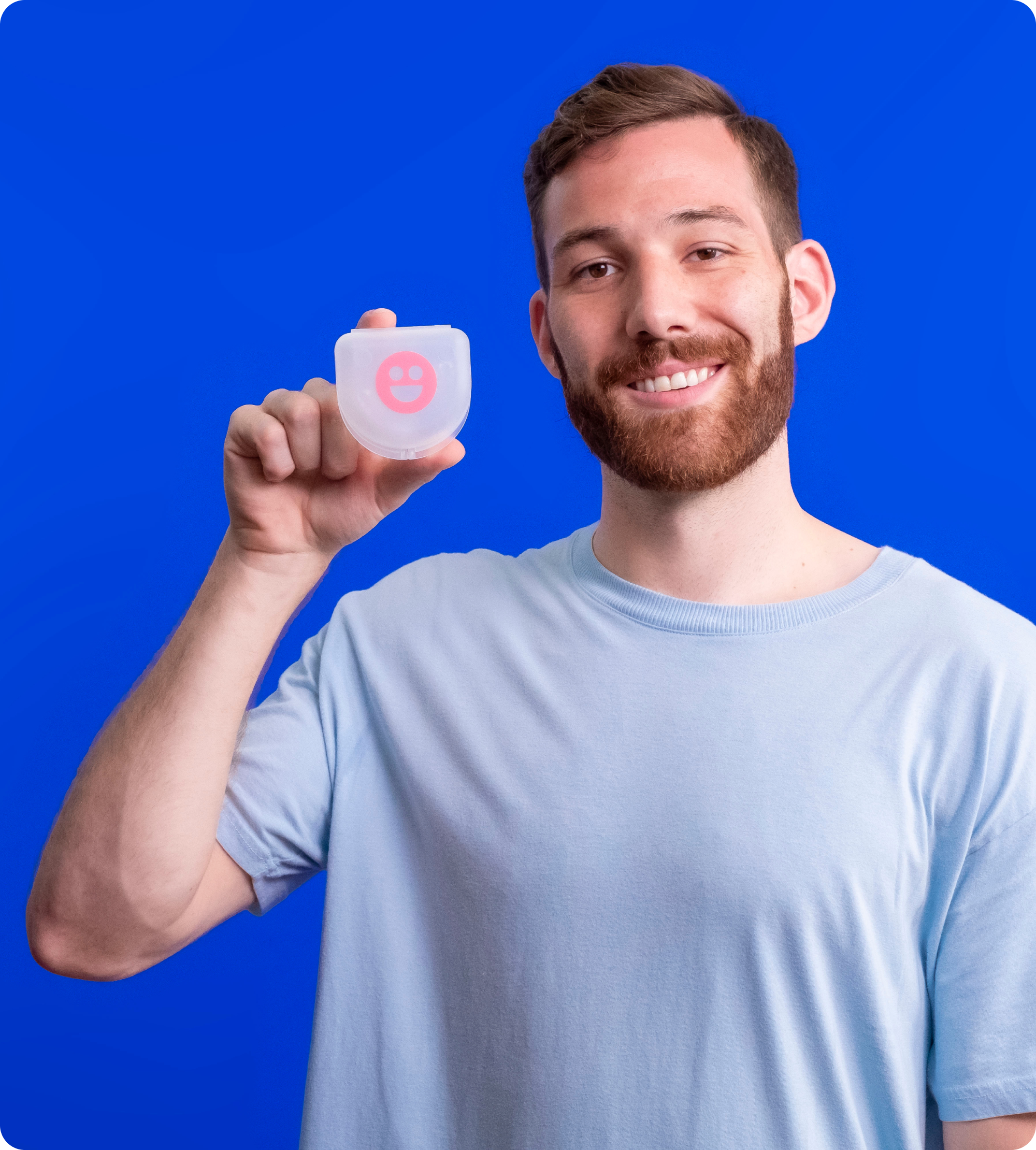 A man is holding a pink cheeky night guards 2-Cheeky