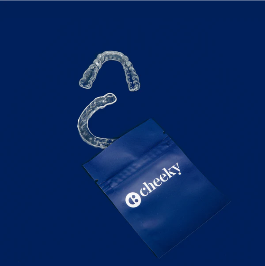 Clear plastic braces resting on a blue background-Cheeky
